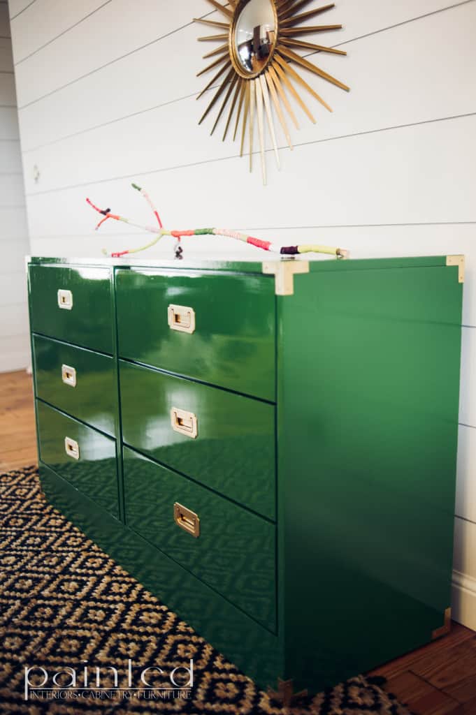 glossy green campaign dresser painted in Fine Paints of Europe Hollandlac Brilliant with brass hardware. ship lap walls. yard covered stick. sunburst mirror