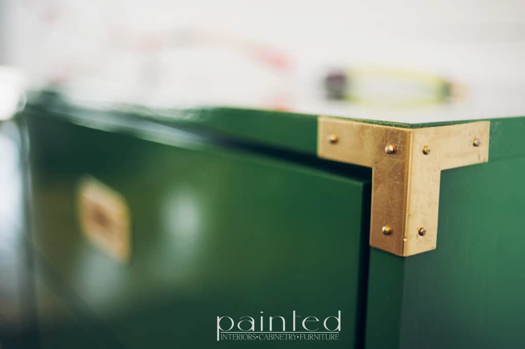 glossy green campaign dresser painted in Fine Paints of Europe Hollandlac Brilliant with brass hardware. brass corner bracket