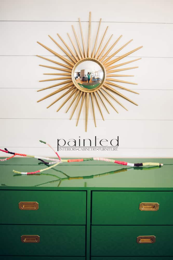 glossy green campaign dresser painted in Fine Paints of Europe Hollandlac Brilliant with brass hardware ship lap walls sunburst mirror yarn covered stick