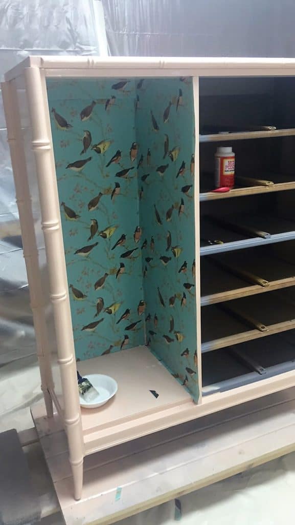 Using Mod Podge to adhere paper into Stanley bamboo Tallboy wardrobe 