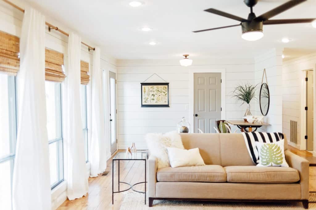 White curtains and bamboo blinds keep this modern farmhouse feeling relaxed and casual.