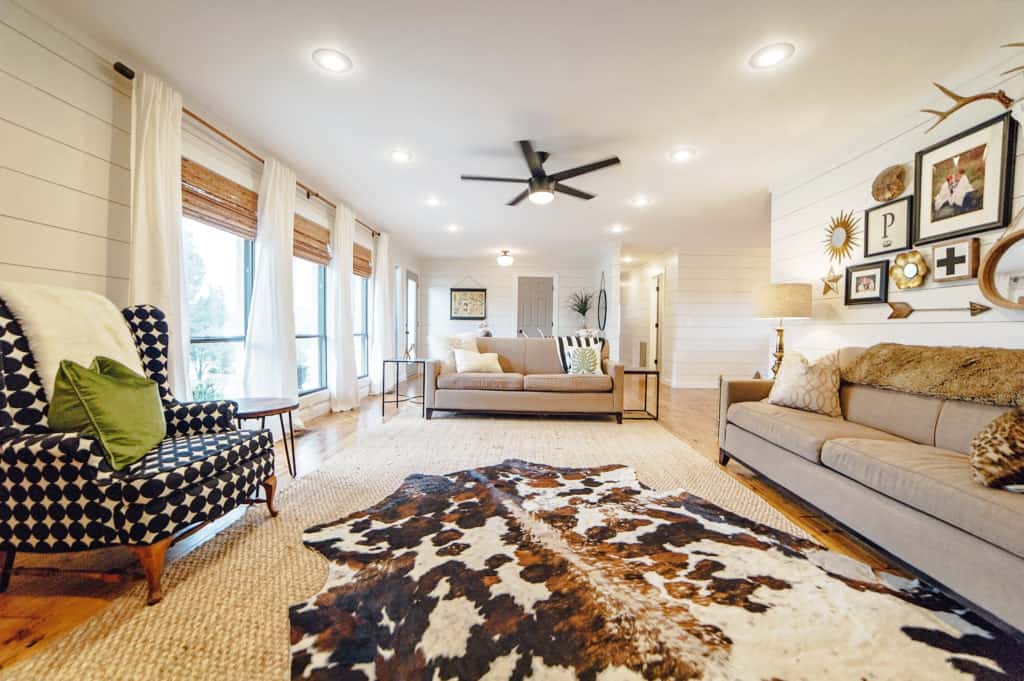 Cowhide layered over a Jute rug brings a ton of natural texture into this updated living room!