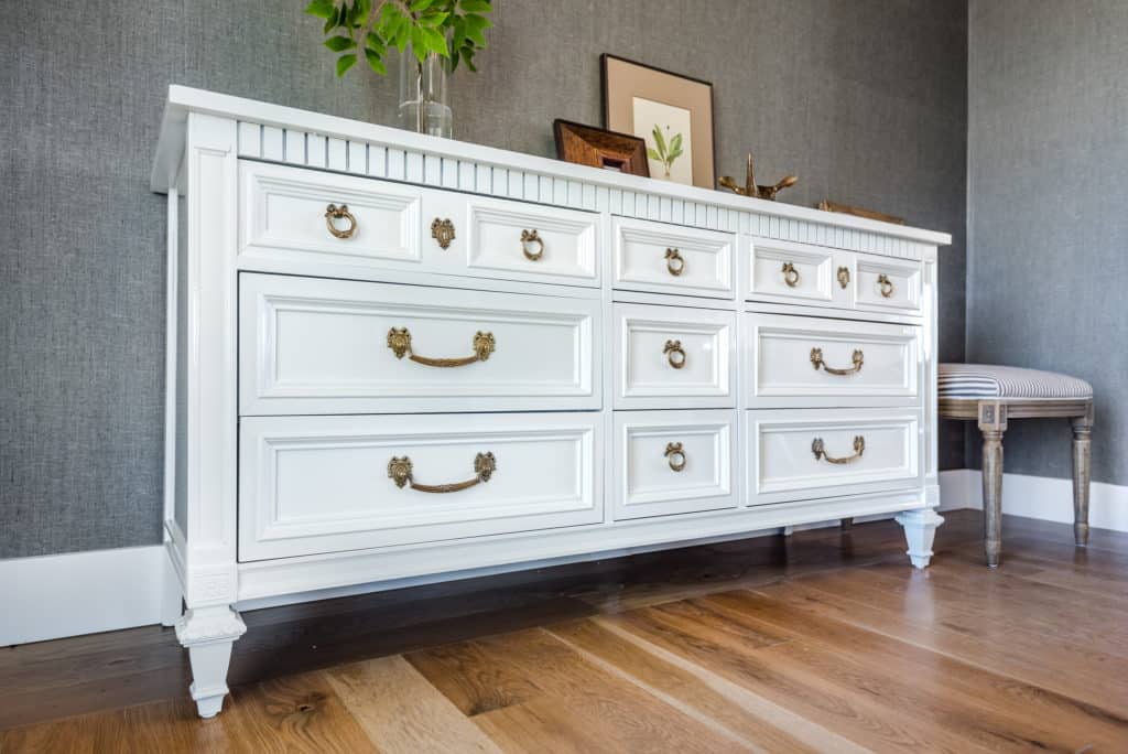 Glossy white dresser with brass hardware