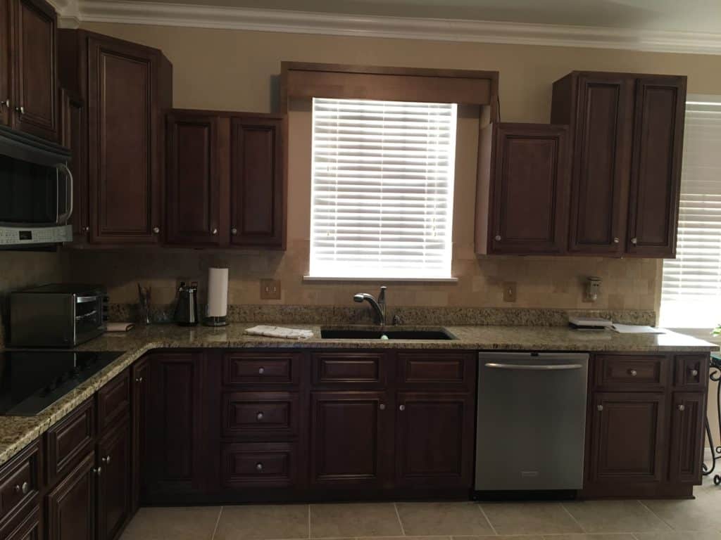 Dated and dark stained kitchen cabinets