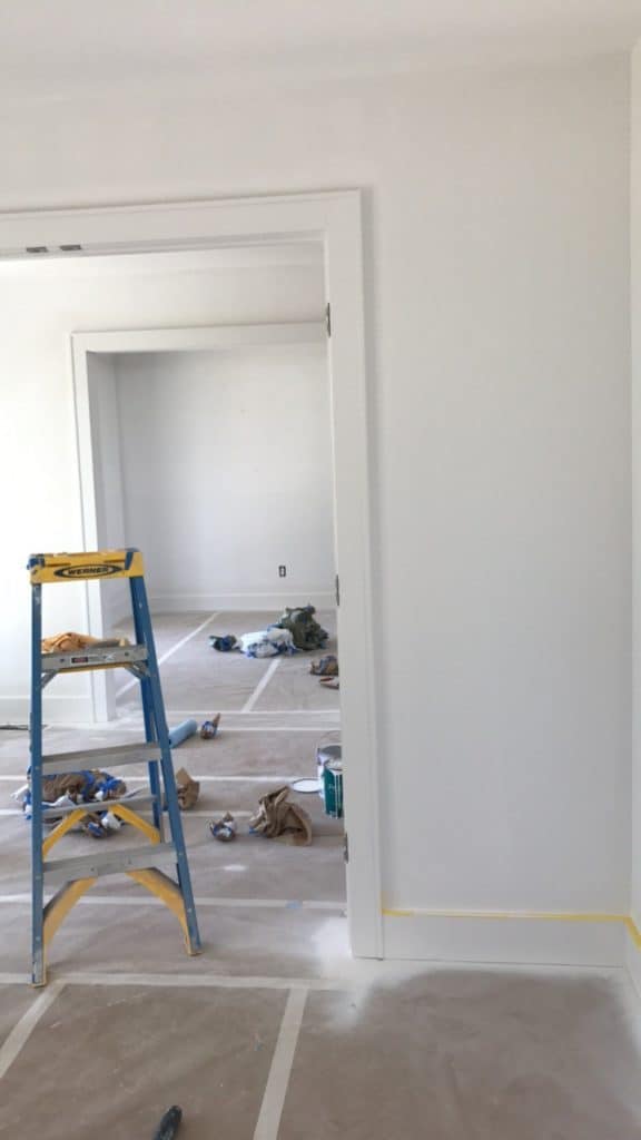 Professionally spraying trim in new construction home.