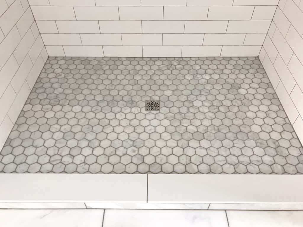Marble hexagon tile for walk in shower in master bathroom.  Grout color is Oyster Gray.