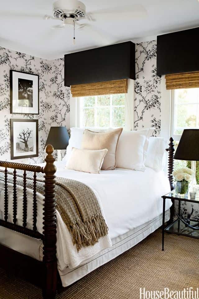 Farmhouse style bedroom with black and white floral wallpaper.