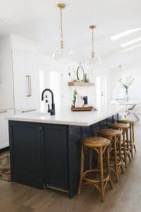 Black kitchen faucet with brass hardware.