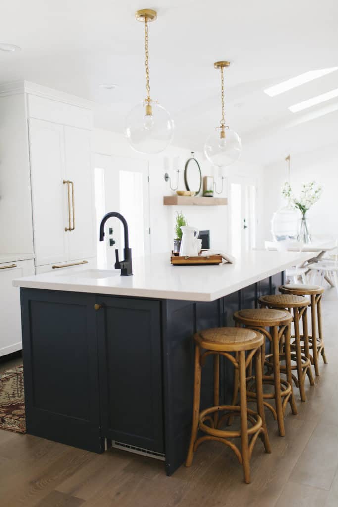 Black kitchen faucet with brass hardware.