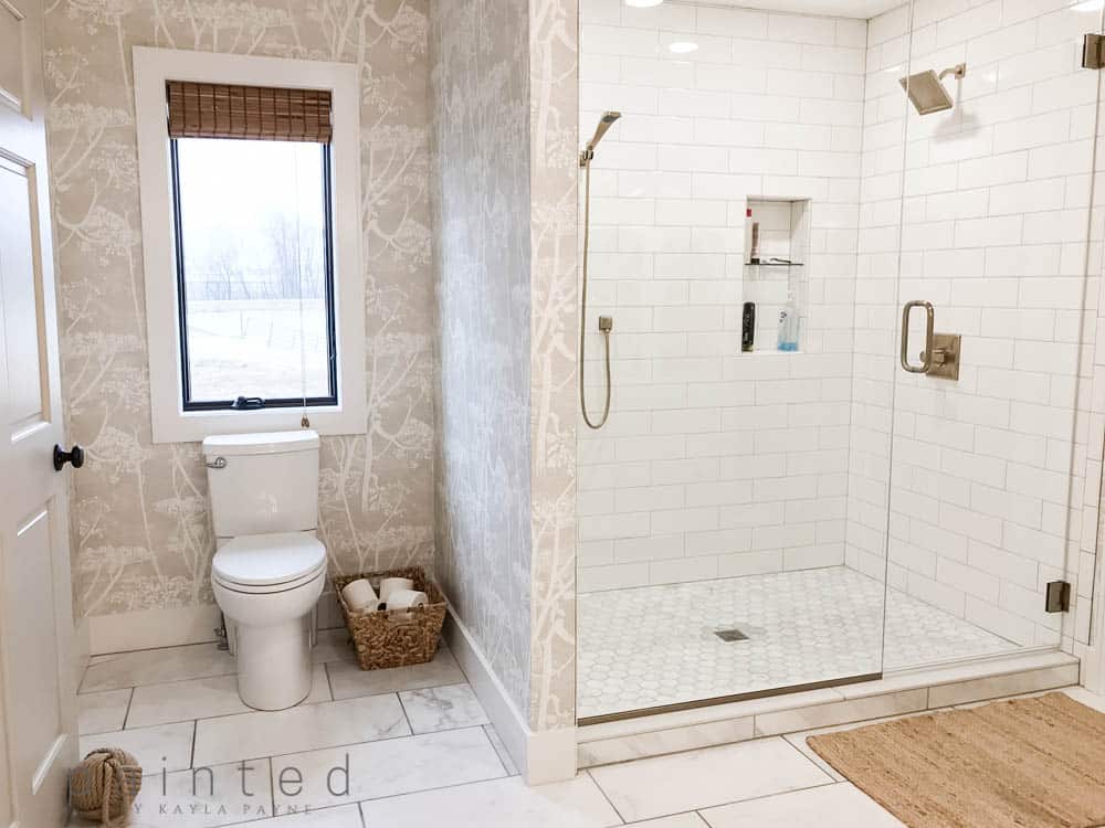 Walk in shower with subway tile and frameless glass shower doors