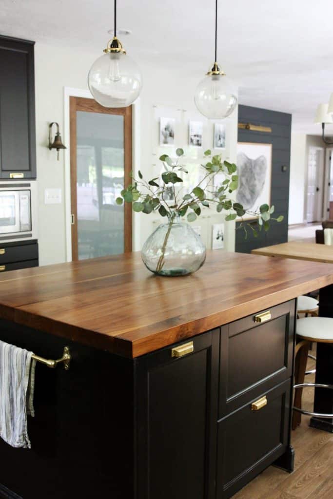 chris loves julia kitchen. modern kitchen decor. black kitchen island. butcher block counter top island. walnut butcher block countertop. how to decorate your kitchen.5 kitchen decor items you should pitch