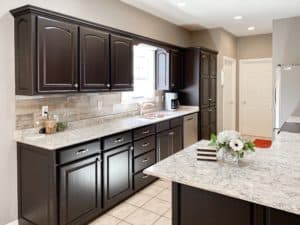 It's true, not everyone wants white kitchen cabinets! General Finishes Milk Paint in Dark Chocolate gives this 90's kitchen a modern facelift!