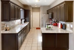 It's true, not everyone wants white kitchen cabinets! These cabinets went from 90's honey colored Oak, to sleek and modern Dark Chocolate! See how painting your kitchen cabinets can instantly update your home!