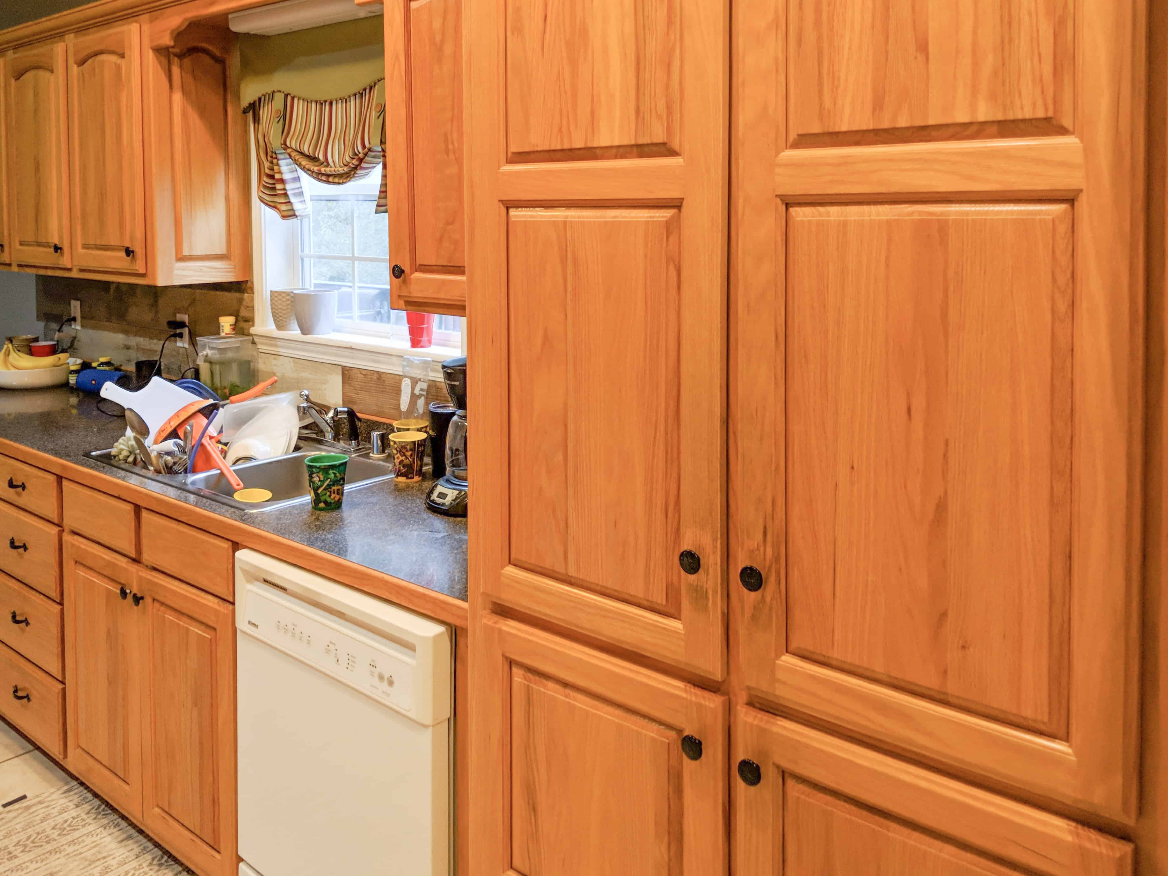 brown cabinets with white table and chair in kitchen ideas