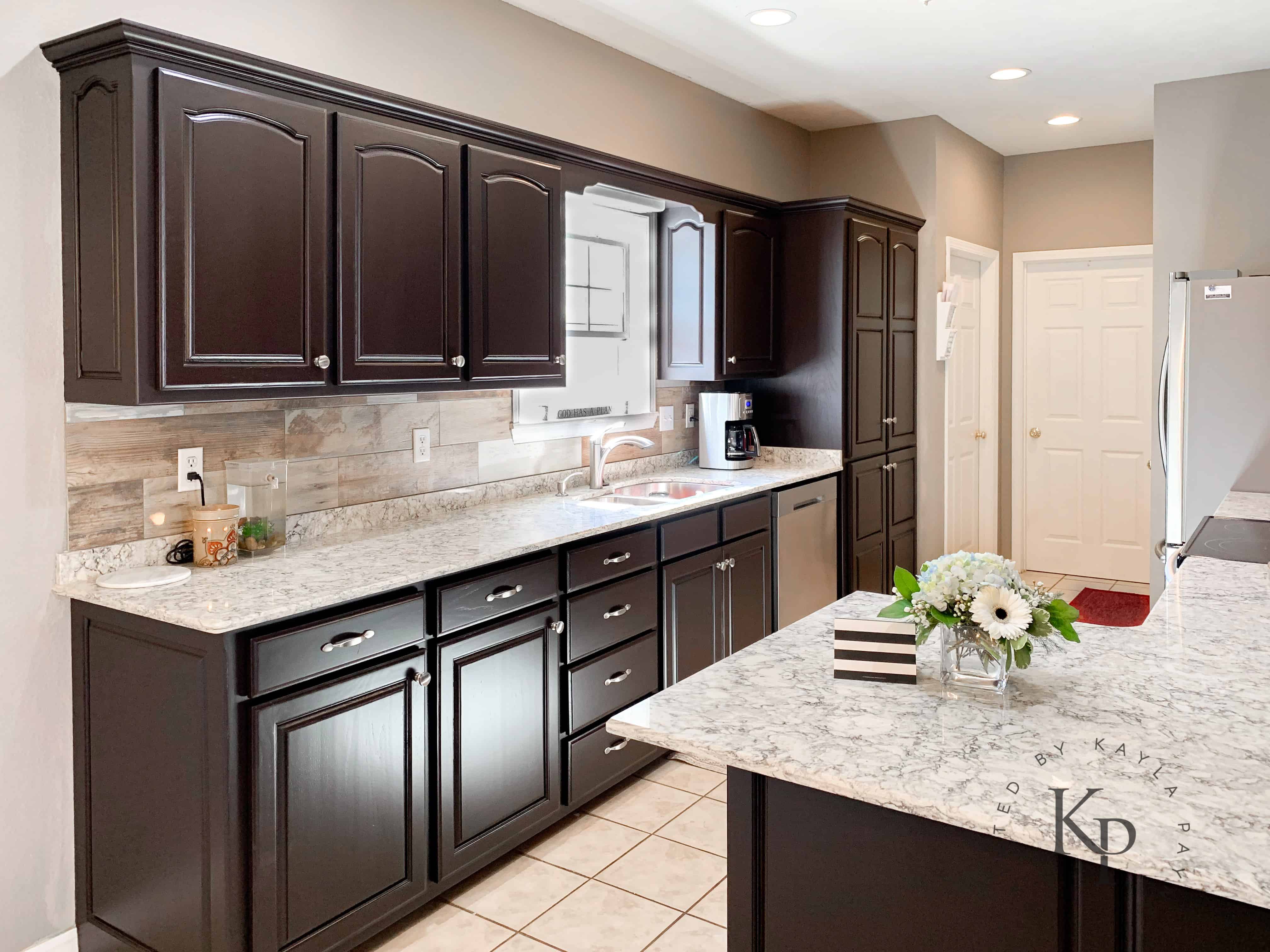 Espresso kitchen cabinets with white countertops