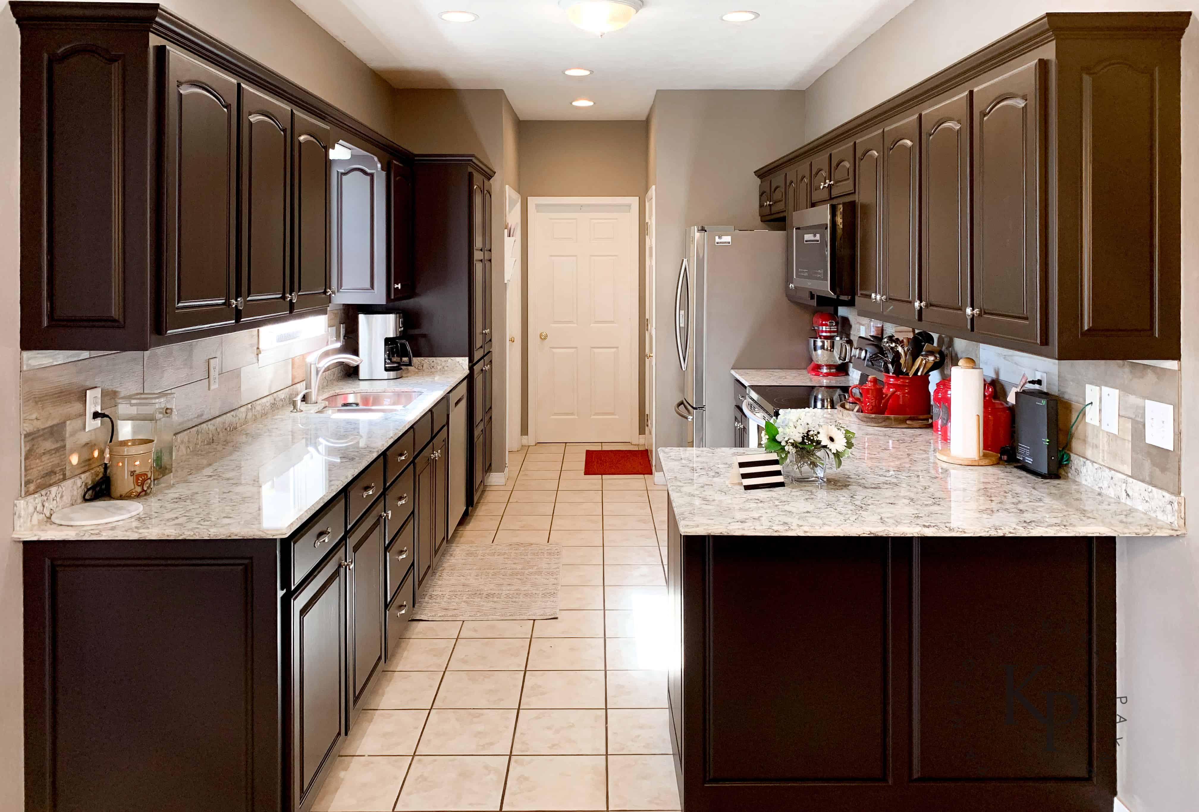 Dark espresso cabinets with light granite countertops. Not everyone wants white kitchen cabinets!