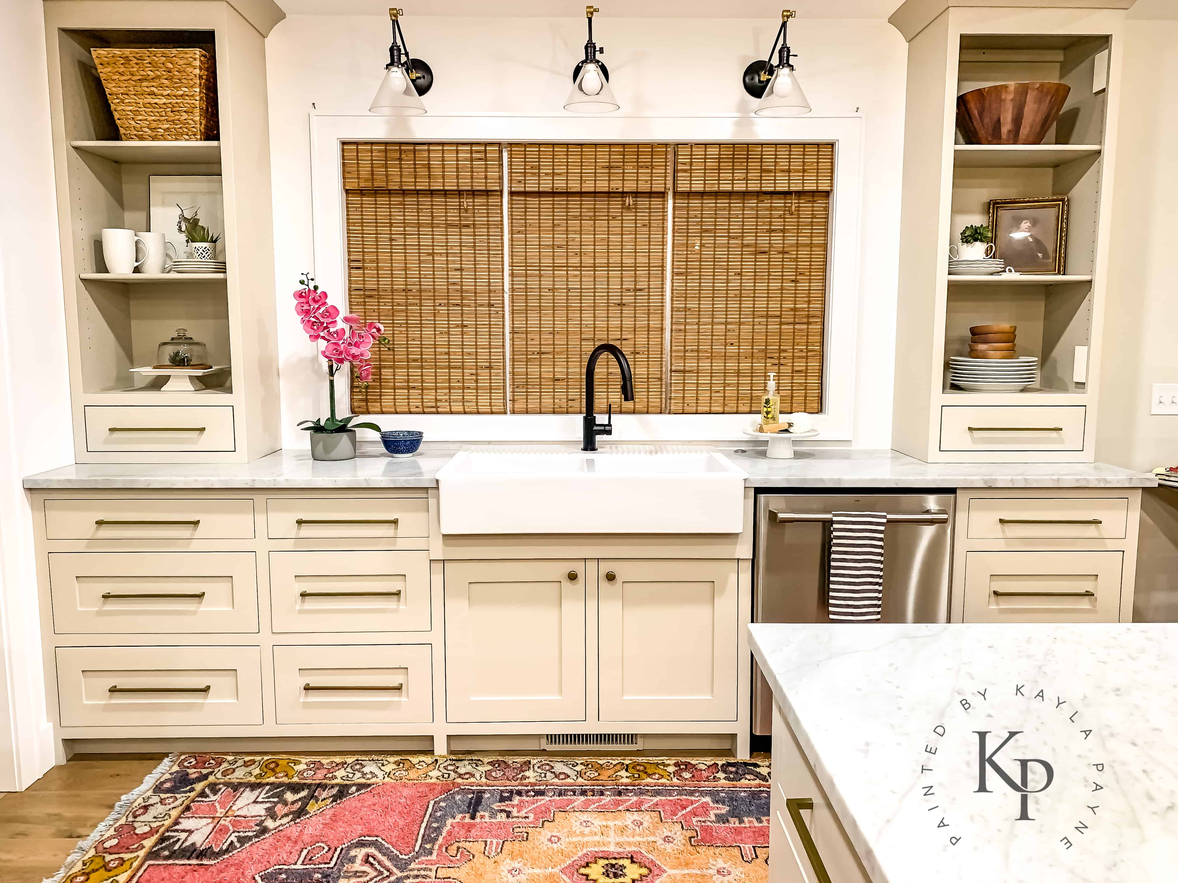 Farmhouse sink with black faucet. Revere Pewter kitchen cabinets