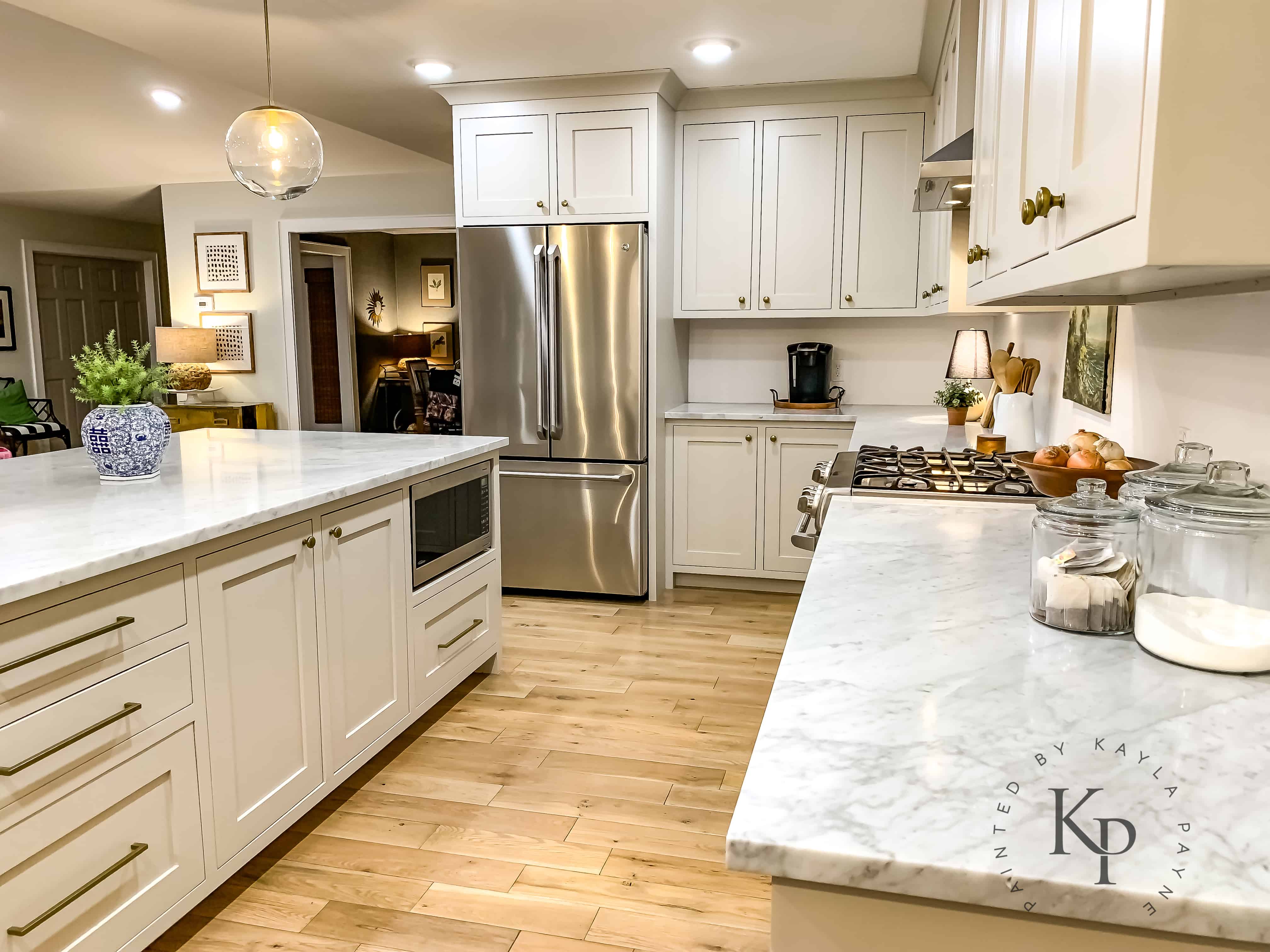 Open concept Kitchen ideas! Cabinets painted in Benjamin Moore Revere Pewter with Carrara Marble countertops.