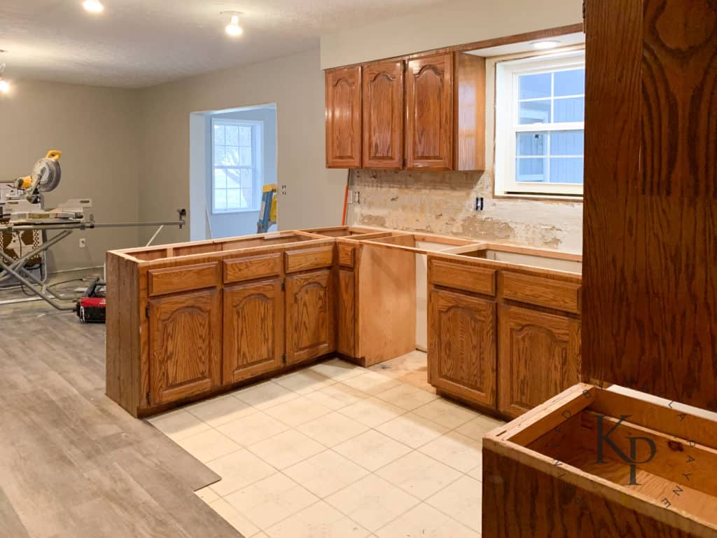 honey oak kitchen cabinets prepped to be painted 