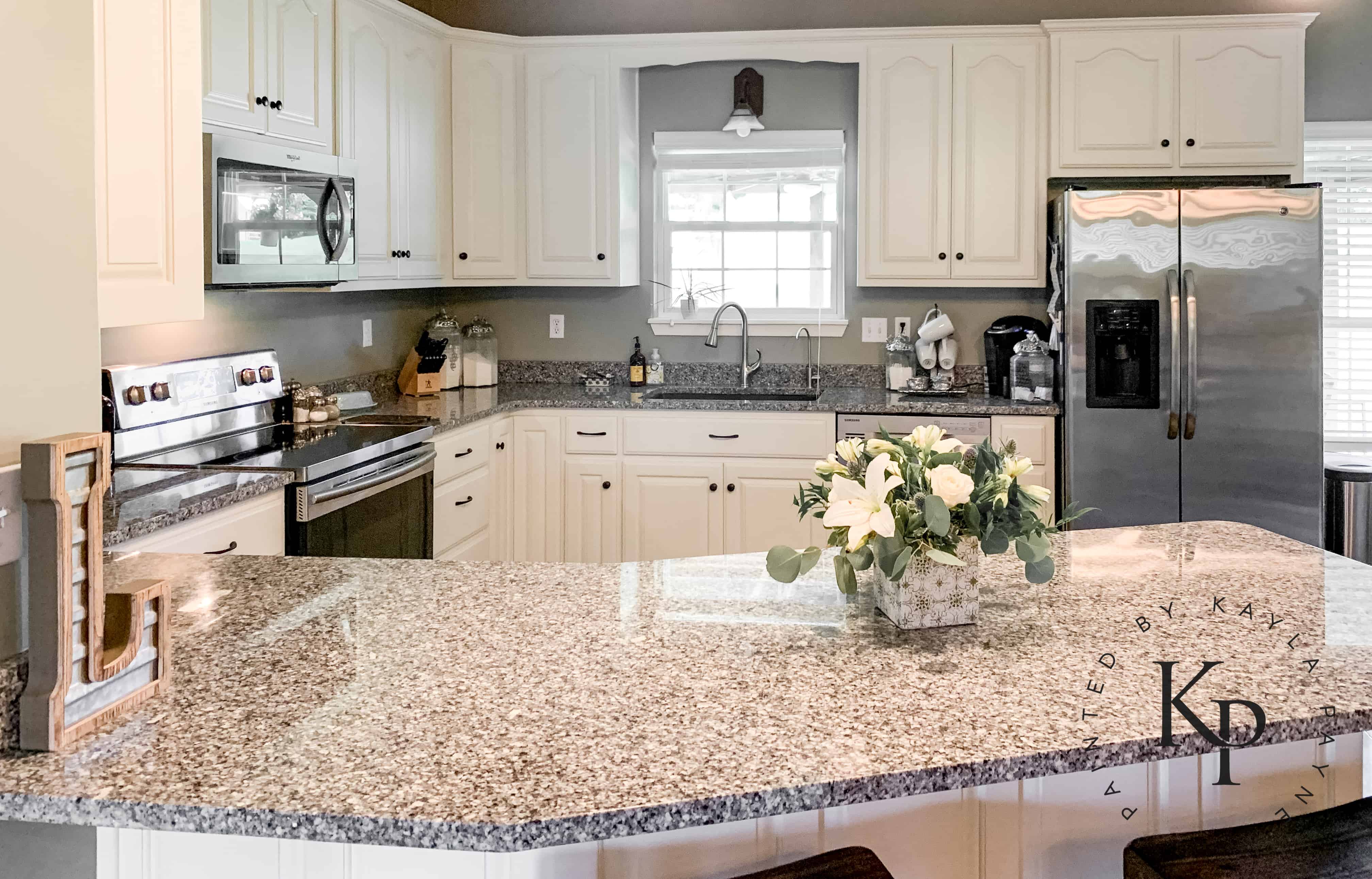 After photo of painted oak kitchen cabinets in Benjamin Moore Soft Chamois 