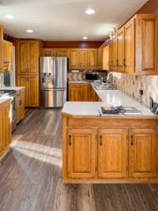 orange colored kitchen cabinets with light counter tops