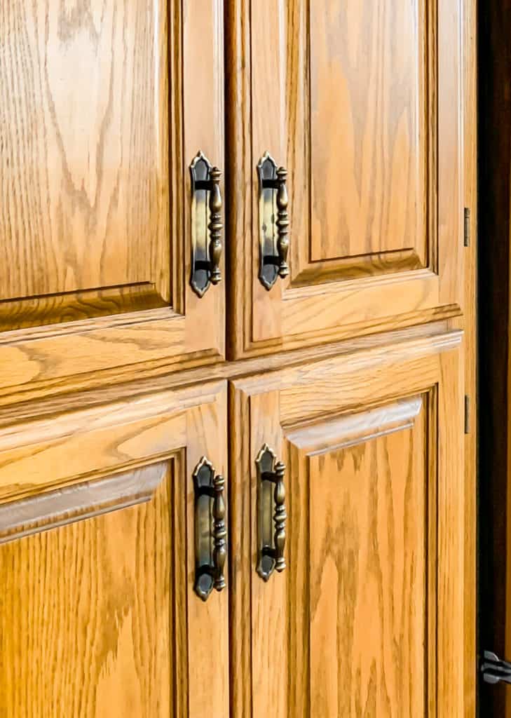 oak cabinets with old gold handles. 