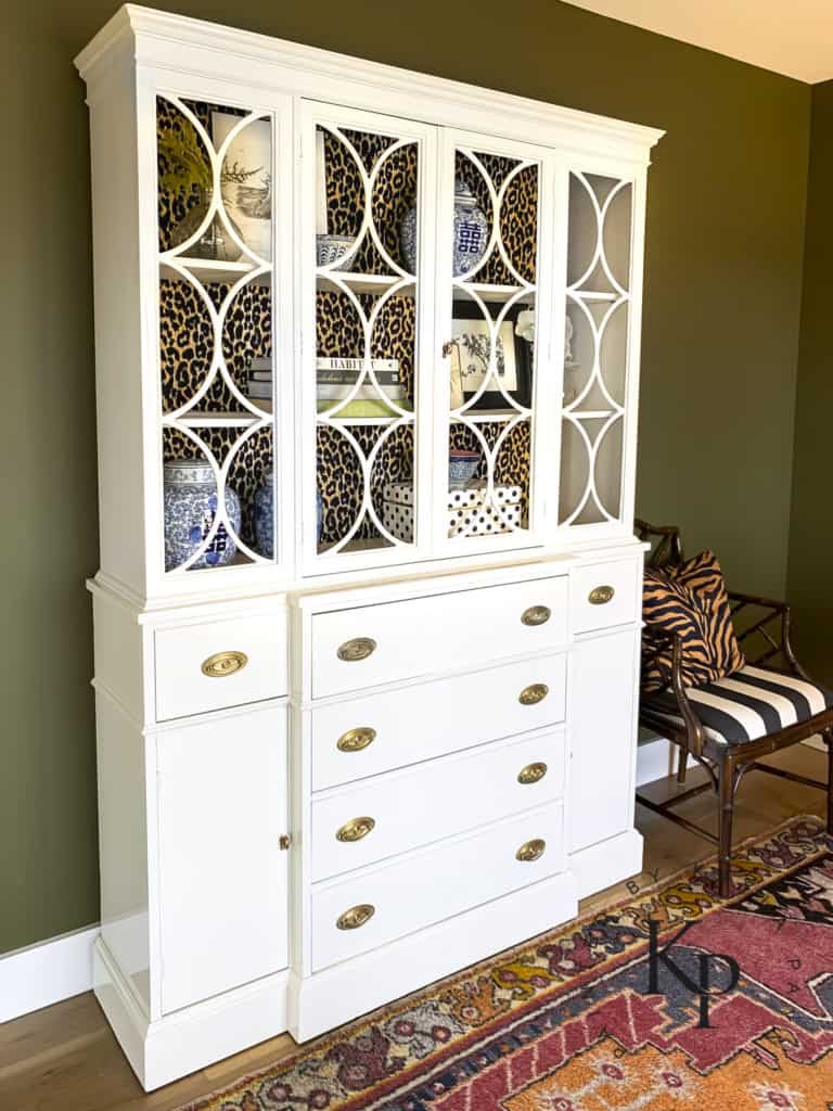 china cabinet with circle fretwork, white painted china cabinet, how to brush hollandlac brilliant, certified fine paints of europe painter, dark green paint color, dark green wall paint color, sherwin williams palm leaf, dark olive paint colors, dark green moody office 