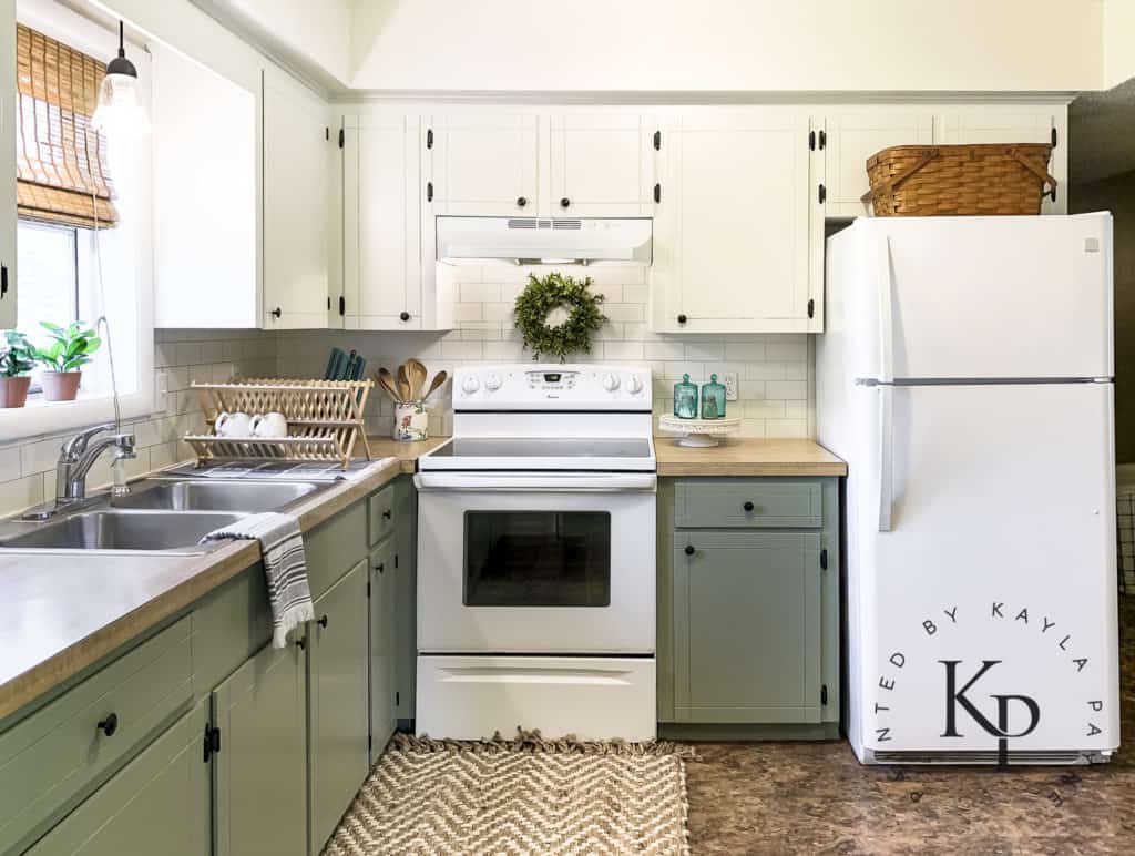 budget kitchen makeover, two tone kitchen cabinets, green lower cabinets white upper, white cabinets on top and green on bottom, sherwin williams green onyx, sage green cabinets, faux butcher block counters with green cabinets, sherwin williams ivory lace cabinets, before and after kitchen pictures