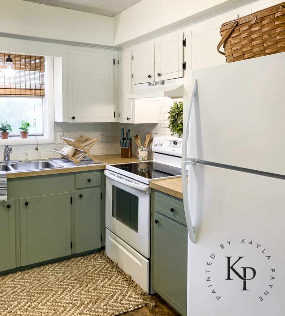 how to make a small kitchen look bigger, budget kitchen makeover, kitchen before and afters, two tone cabinets in kitchen, green kitchen cabinets, sherwin williams green onyx, sherwin williams ivory lace cabinets, sage green kitchen cabinets, white appliances with painted cabinets, faux subway tile backsplash, draw backsplash with sharpie