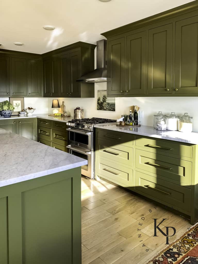 Dark green kitchen cabinets with Carrara marble countertops