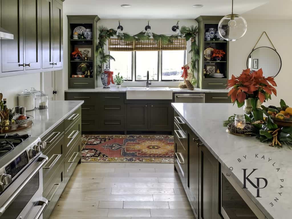Kitchen with green cabinets decorated for Christmas
