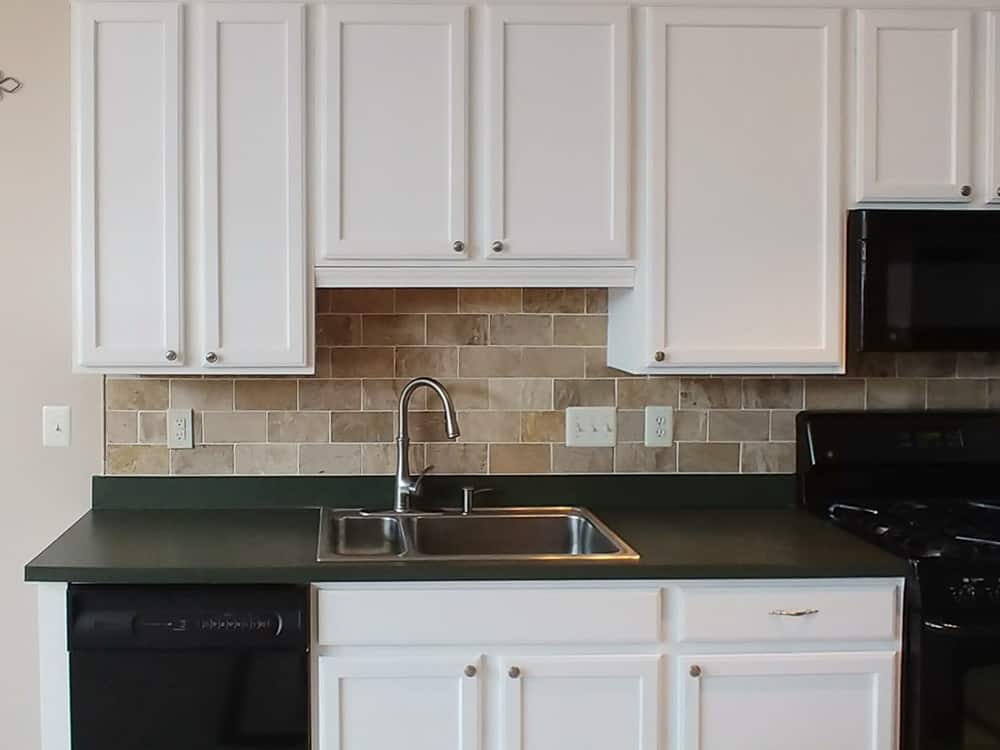 creamy white kitchen cabinets with dark countertops. 