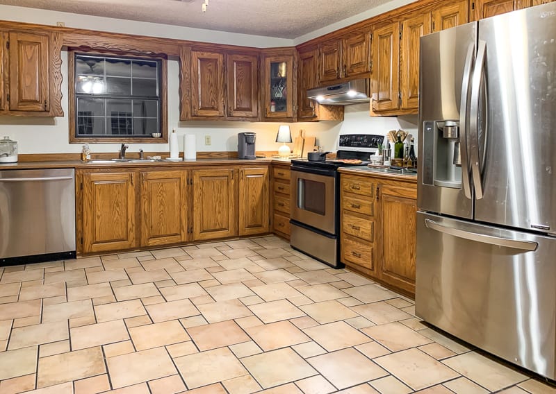 Dated kitchen with oak cabinets and green countertop