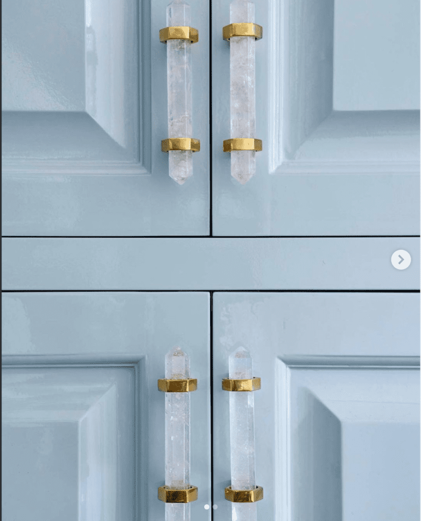 lucite and brass cabinet pulls on lacquered cabinets