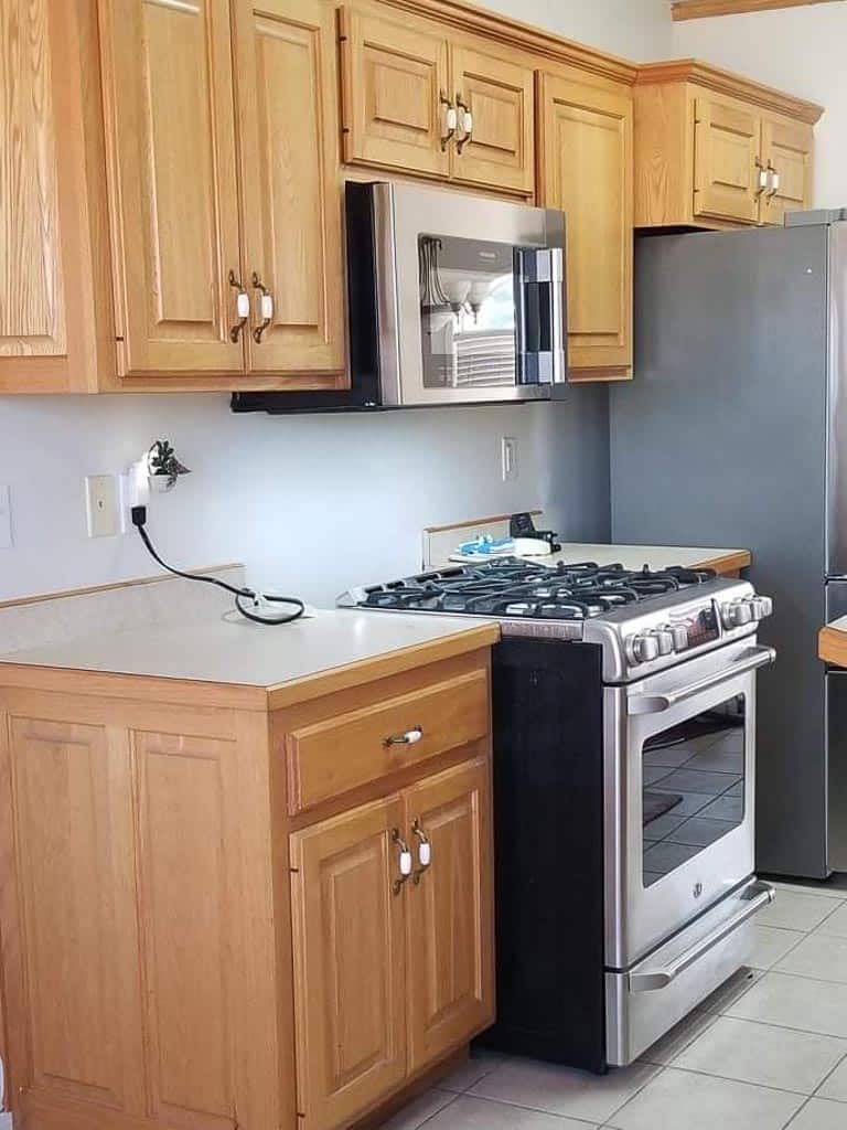 builder grade honey oak cabinets in a plain, boring kitchen