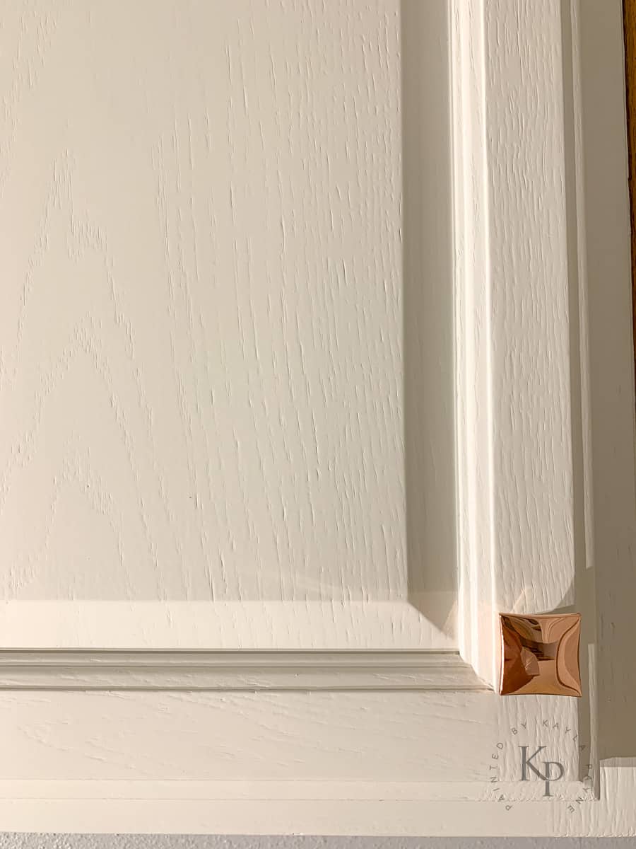A painted Oak cabinet door that shows how the grain pattern is still visible.