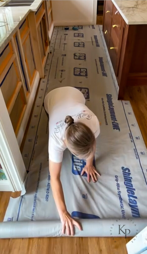 Using shingle underlayment as floor protection when prepping to paint cabinets